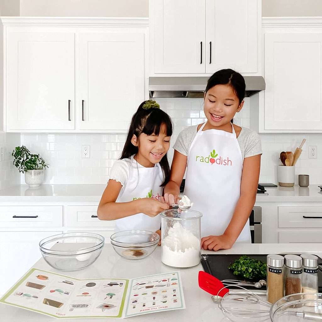 two kids cooking a Raddish Kid meal n the kitchen