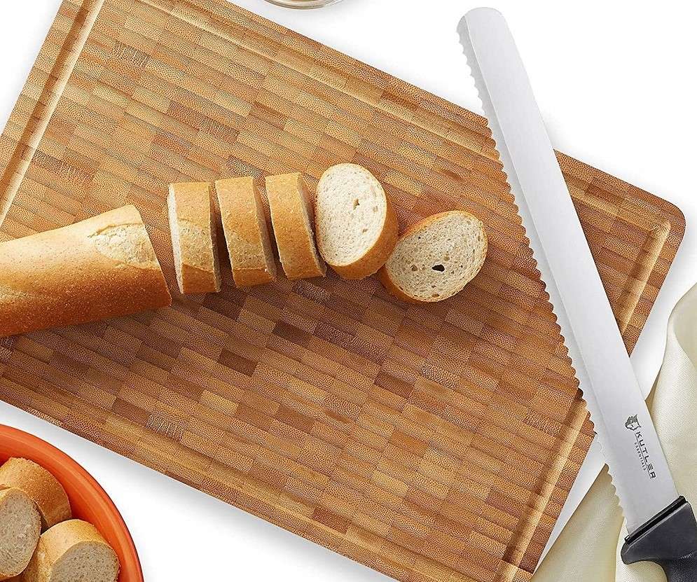 sliced bread and a bread knife on a cutting board.