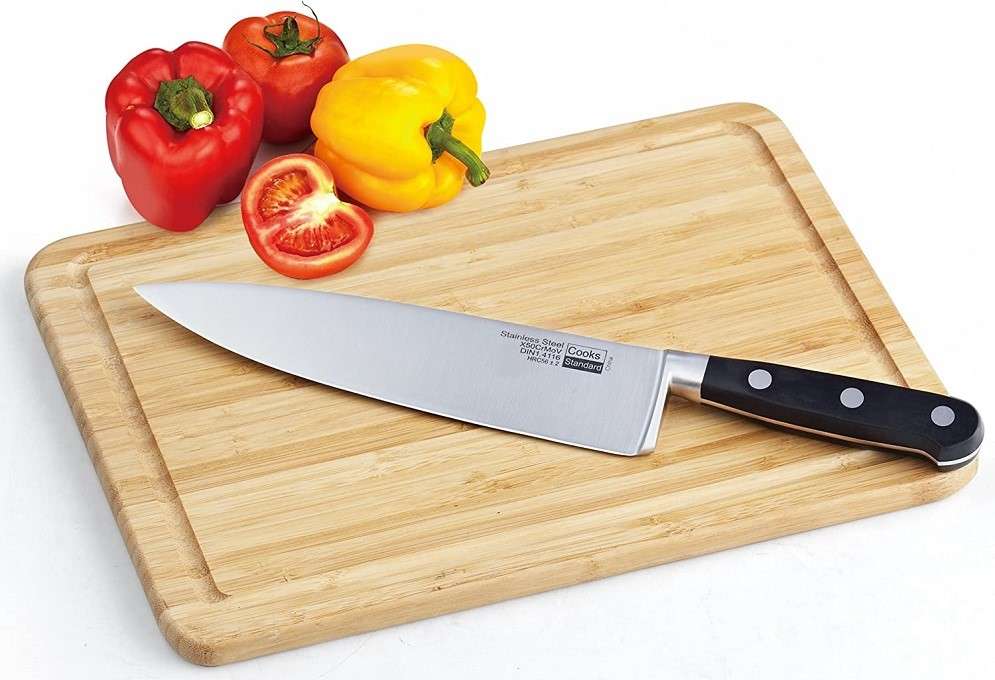 cutting board with a chef's knife on it.