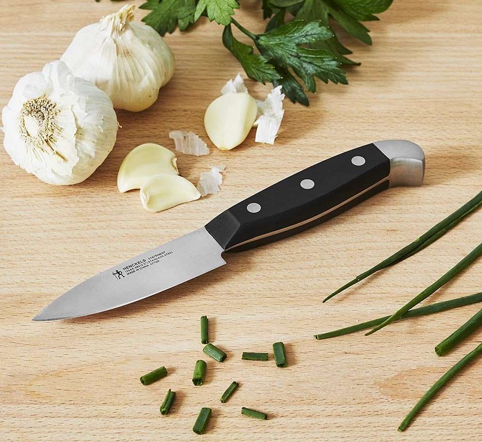 table top with paring knife and some vegetables